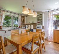 Küche in einem Einfamilienhaus mit Holztisch und Dekor, in hellen Farben.