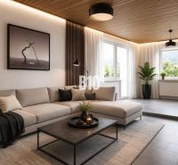 Ein stilvolles Wohnzimmer in einem Einfamilienhaus mit einem bequemen Sofa und Blick in die Natur.