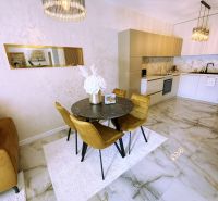Essbereich in einer 2-Zimmer-Wohnung mit Marmorboden und eleganter Beleuchtung.
