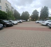 Parkplatz mit Autos in der Športová-Straße in Dunajská Lužná vor dem Gebäude.
