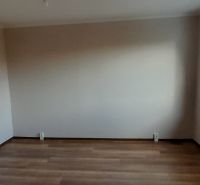 Ein Zimmer in einer 2-Zimmer-Wohnung mit einem Holzboden und einem großen Fenster.