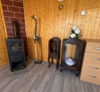 Holzinterieur der Hütte mit Ofen, Giraffe und Möbeln auf dem Boden mit Holzdekor.