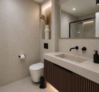 Badezimmer mit Dusche und Waschbecken mit Spiegel in einer 4-Zimmer-Wohnung.