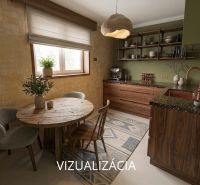 Küche in einer 2-Zimmer-Wohnung mit Holzmöbeln und rundem Tisch.