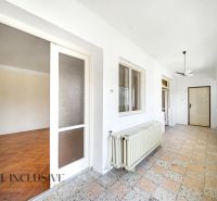 Flur mit bedecktem Boden, großem Fenster und Türen in einem Einfamilienhaus.