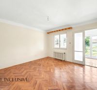 Ein heller Raum mit Holzboden und Blick in den Garten in einem Einfamilienhaus.