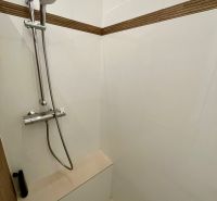 Duschkabine mit Handbrause und Fliesen in einer 3-Zimmer-Wohnung.