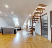 Wohnzimmer im Dachgeschoss in einer 4-Zimmer-Wohnung, Boden mit Holzdekor, Wendeltreppe.