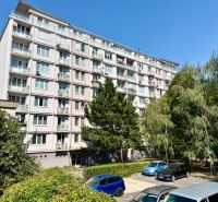 Mehrfamilienhaus in der Piešťanská Straße in Bratislava - Nové Mesto, umgeben von Grünflächen und einem Parkplatz.