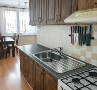 Küche in einer 3-Zimmer-Wohnung mit Holzboden und stilvollen Schränken.