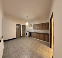 Küche in einem Einfamilienhaus mit Holzboden und hölzernen Küchenschränken.