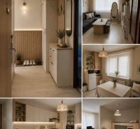 Gemütliches Interieur einer 2-Zimmer-Wohnung mit Holzboden und sanften Dekorationen.