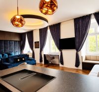 Innenraum einer 2-Zimmer-Wohnung mit eingebauter Beleuchtung, Vorhängen und einem Boden in Holzoptik.