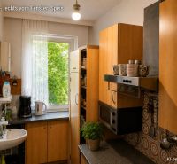 Küche in einem Einfamilienhaus mit Holzdekor-Schränken und Geräten.