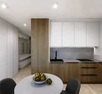 Küchenbereich in einer 3-Zimmer-Wohnung mit Holzboden und weißen Schränken.