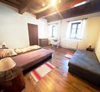 Eine Hütte mit zwei Sofas, einem Boden mit Holzdekor und einer Holzdecke.