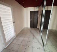 Flur in einer 3-Zimmer-Wohnung mit Fliesen, einem Spiegelschrank und dunklen Türen.