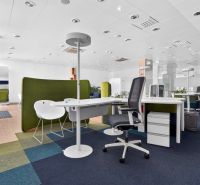 Bürogeschäftsräume mit offener Bestuhlung, Teppichfliesen und Bürotischen.