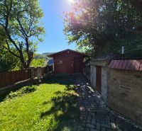 Garten bei einem Einfamilienhaus in Mikušovce, Sitzecke in der Natur, sonniger Tag, Steinweg.