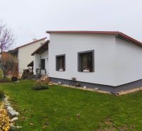Ein Einfamilienhaus in der Vinohradnícka-Straße in Veľký Krtíš mit einem Rasen-Garten und einem Baum.