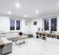 Wohnzimmer in einem Einfamilienhaus mit Holzboden und modernen Möbeln.