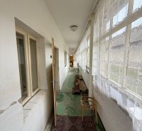 Ein heller Flur in einem Einfamilienhaus mit Teppich und Vorhängen.