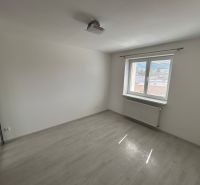 Ein leerer Raum mit Holzboden und weißen Wänden in einer 3-Zimmer-Wohnung.