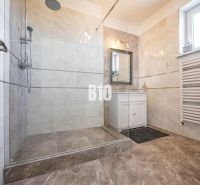Badezimmer in einem Einfamilienhaus mit geräumiger Dusche und Waschbecken.