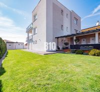 Ein Einfamilienhaus in Nitra mit einem geräumigen Garten und grünem Rasen.
