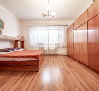 Schlafzimmer in einem Einfamilienhaus mit Bett, Schrank und Boden mit Holzdekor.