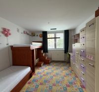 Kinderzimmer in einer 3-Zimmer-Wohnung mit einem bunten Teppich und einem Etagenbett.