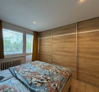 Schlafzimmer in einer 3-Zimmer-Wohnung mit Holzboden und Kleiderschrank.