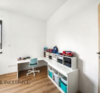Kinderzimmer in einem Einfamilienhaus mit Holzboden und Aufbewahrungsregalen.