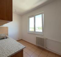 Küche in einer 2-Zimmer-Wohnung mit Keramikboden, einfachen Schränken und einem Fenster mit Aussicht.