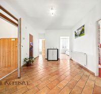 Ein geräumiger Flur mit Fliesenboden in einem Einfamilienhaus, mit Holzelementen im Innenraum.