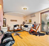 Wohnzimmer in einem Einfamilienhaus mit Kamin und Boden in Holzoptik.
