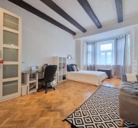 Schlafzimmer in einer 3-Zimmer-Wohnung mit Holzboden und Deckenbalken.