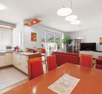 Wohnzimmer mit Küche in einer 4-Zimmer-Wohnung und einem Boden mit Holzdekor.