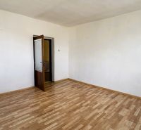 Ein Zimmer in einem Einfamilienhaus mit Holzboden und offenen Türen.