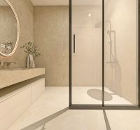 Badezimmer mit geräumiger Dusche und Waschmaschine in einer 2-Zimmer-Wohnung.