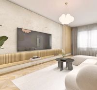 Wohnzimmer mit Holzboden und heller Couch in einer Zweizimmerwohnung.