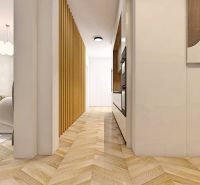 Ein Flur mit Holzboden führt in das Wohnzimmer einer Zweizimmerwohnung.
