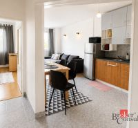 Innenraum einer 2-Zimmer-Wohnung mit Küche, Wohnzimmer und Holzboden.