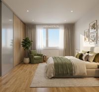 Schlafzimmer in einer 2-Zimmer-Wohnung mit Holzboden und einer Pflanze.