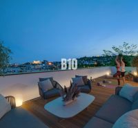Eine Terrasse mit Blick auf die Stadt, bequeme Sitzgelegenheiten und ein Fitnessbereich in einer 3-Zimmer-Wohnung in Bratislava III, Pod Strážami.
