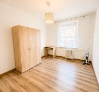 Ein geräumiges Zimmer mit einem Holzboden in einer 3-Zimmer-Wohnung.