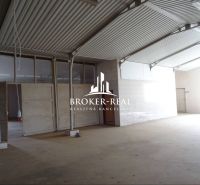 Industriehalle mit vertikalen Trägern und Eingangstüren im Bereich Lager und Hallen.