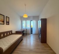 Einfaches Zimmer mit Bett, Schrank und Boden in Holzoptik in einer 3-Zimmer-Wohnung.