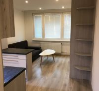 Garçonniere mit Sofa, Tisch und Holzboden.