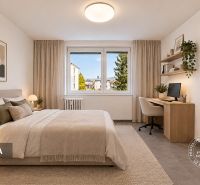 Schlafzimmer in einer 2-Zimmer-Wohnung mit Schreibtisch, großem Fenster und bequemem Bett.